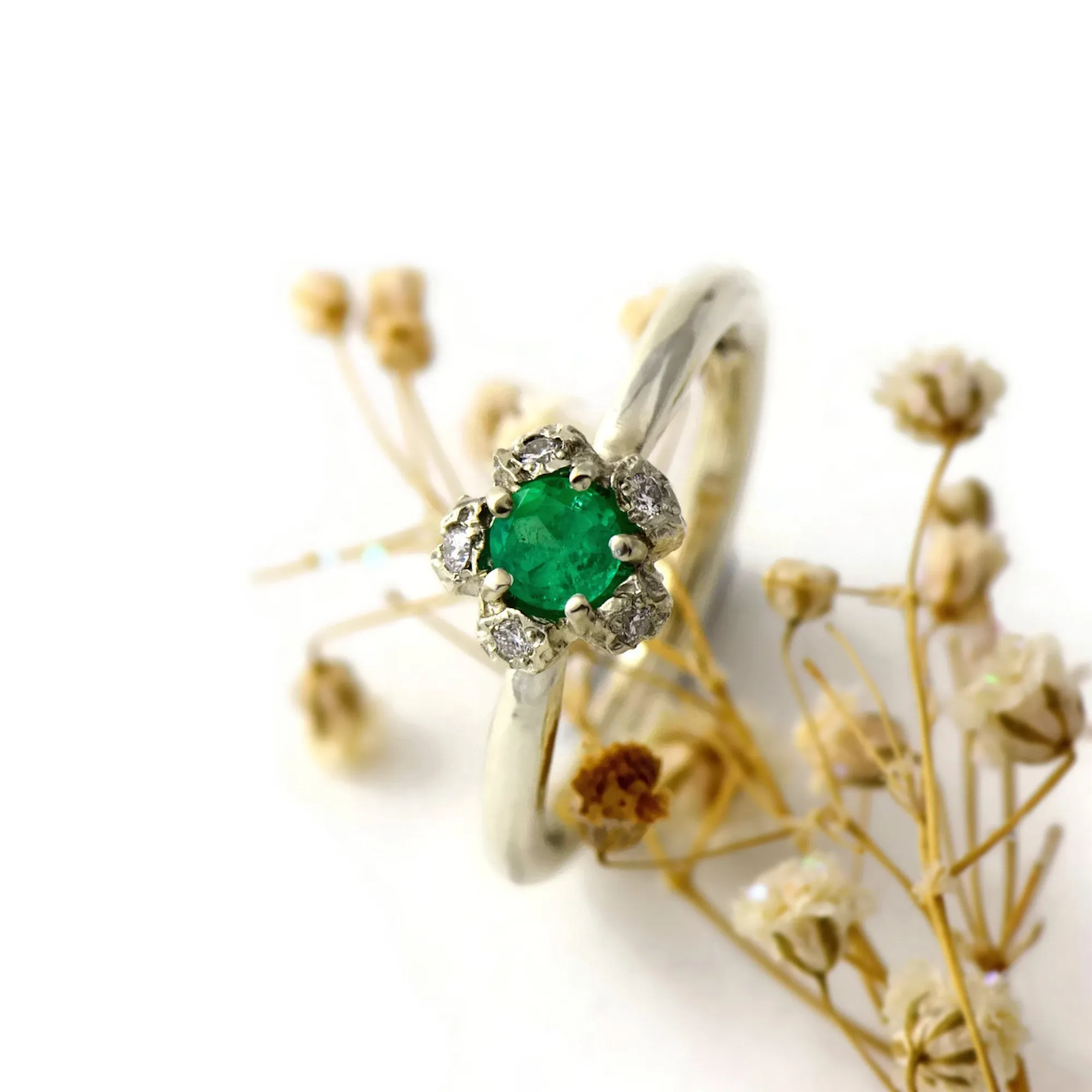 Natural Colombian emerald solitaire engagement ring  with a diamond cluster set in gold peppercorn