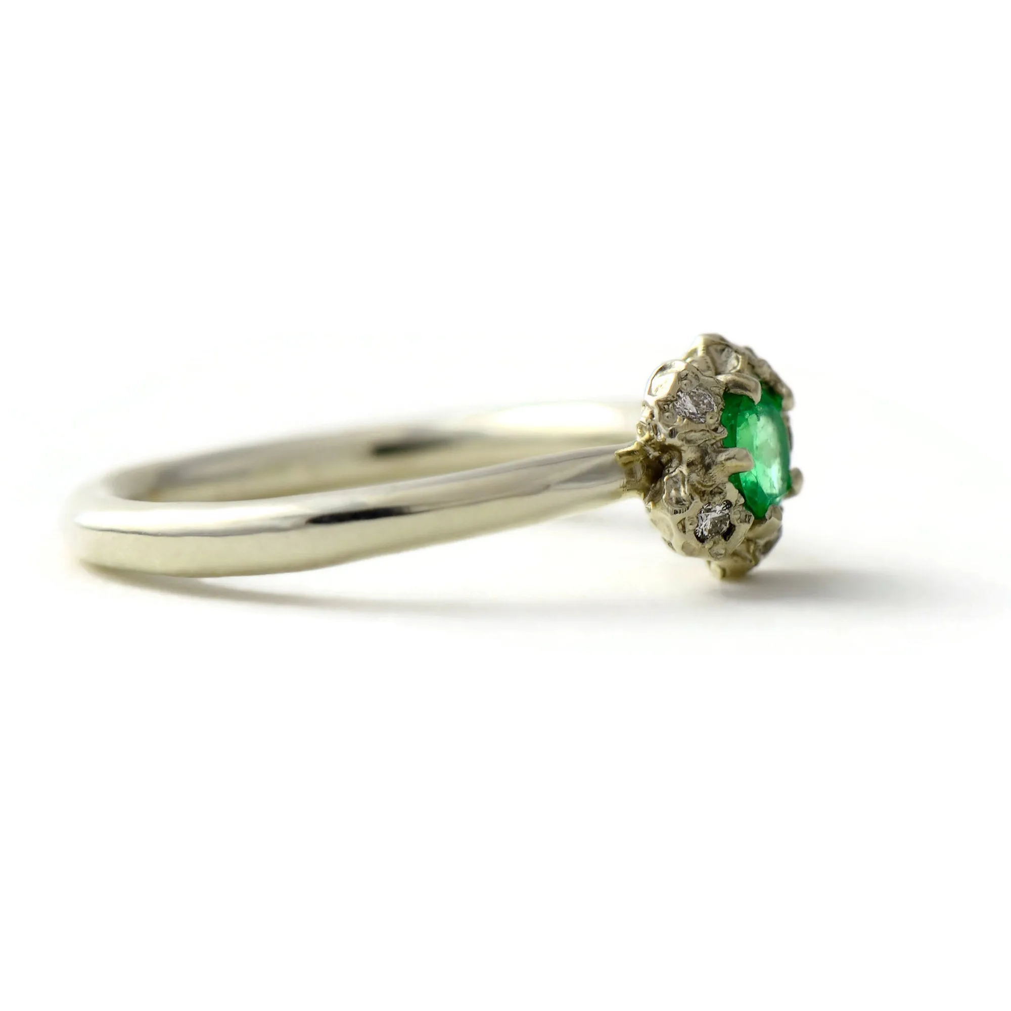 Natural Colombian emerald solitaire engagement ring  with a diamond cluster set in gold peppercorn